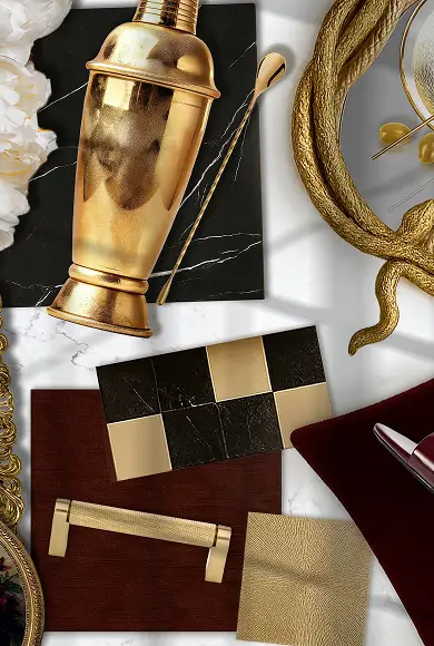 Flat lay with gold cocktail shaker, metallic accents, fabric swatches, and bold black-and-gold design elements.