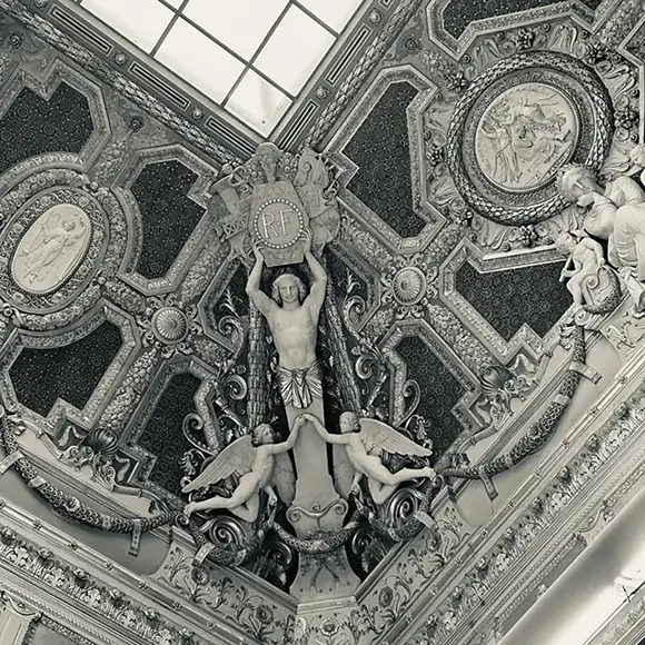 Architectural ceiling detail from Grace Blu’s with black-and-white symmetrical dome design and human and angle sculptures.