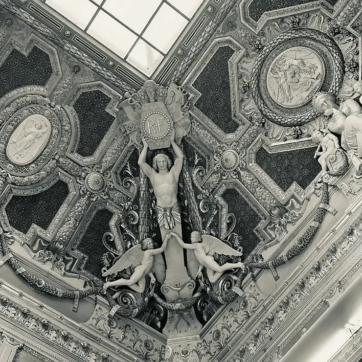 Architectural ceiling detail from Grace Blu’s with black-and-white symmetrical dome design and human and angle sculptures.