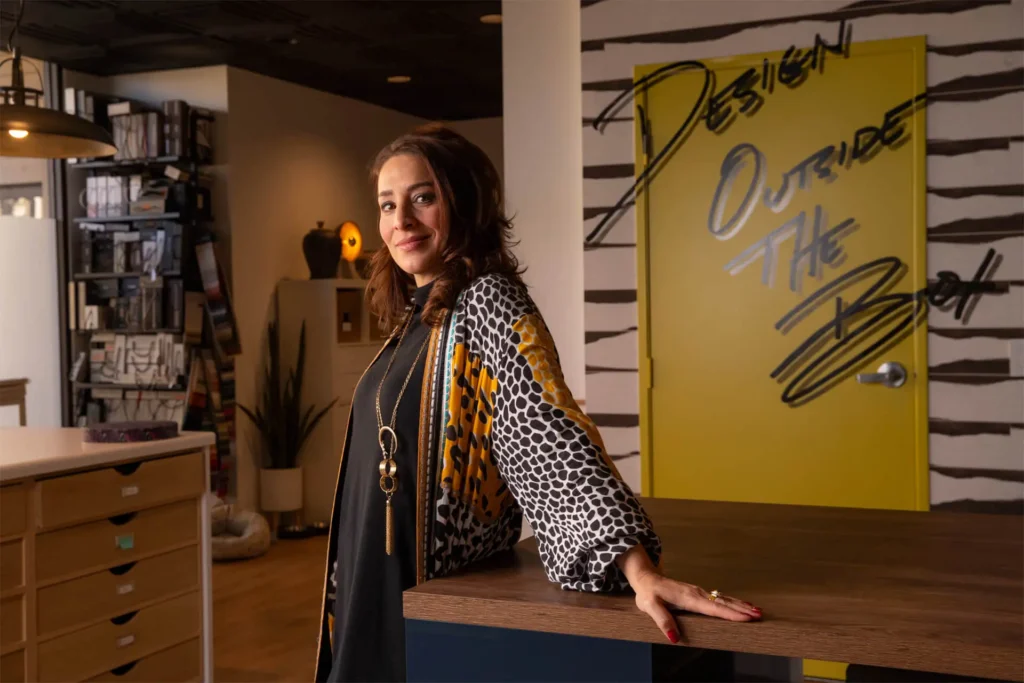 Rona Graf, the founder and lead designer of Grace Blu smiling in the Grace Blu office