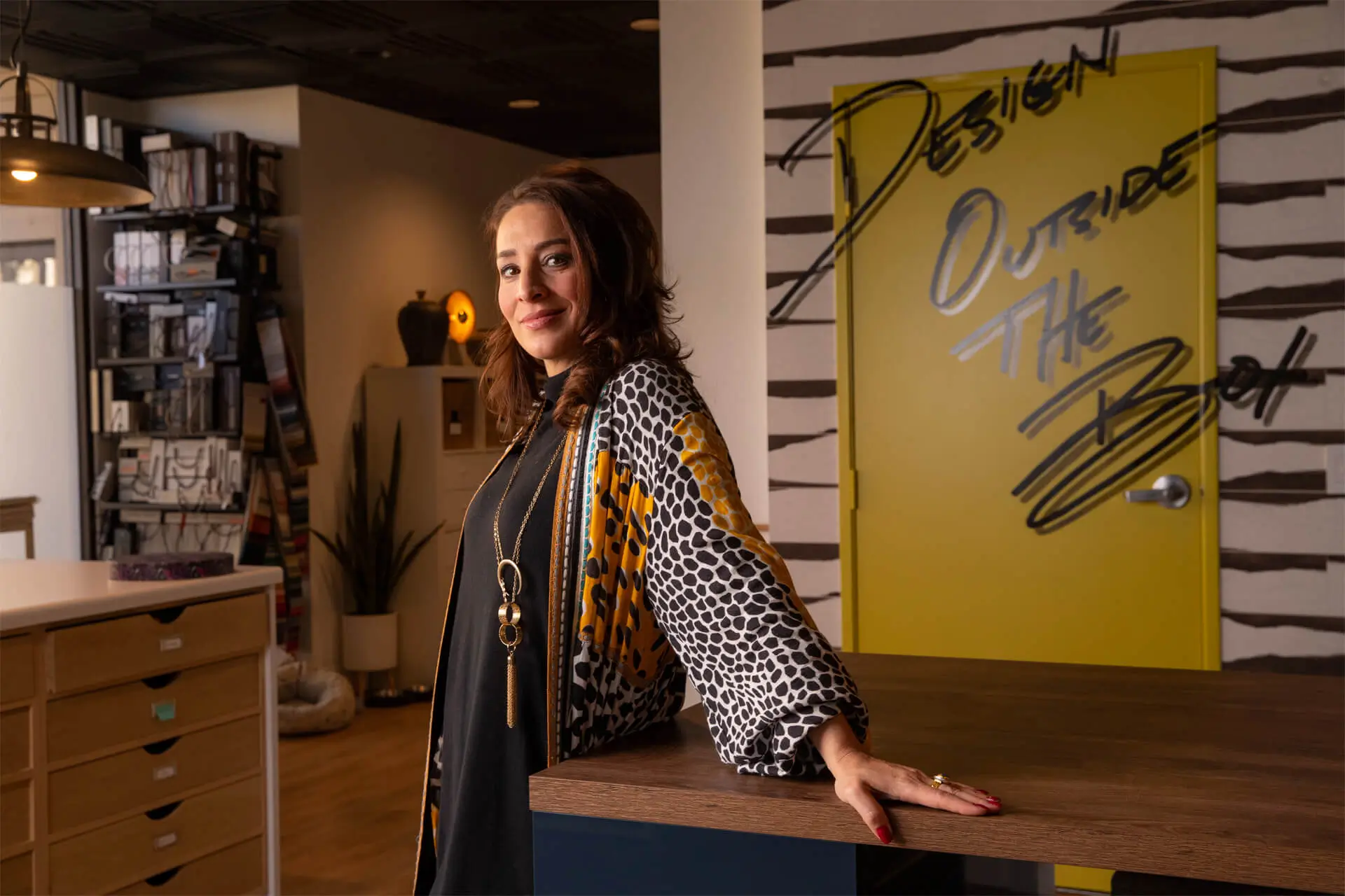 Rona Graf, the founder and lead designer of Grace Blu smiling in the Grace Blu office