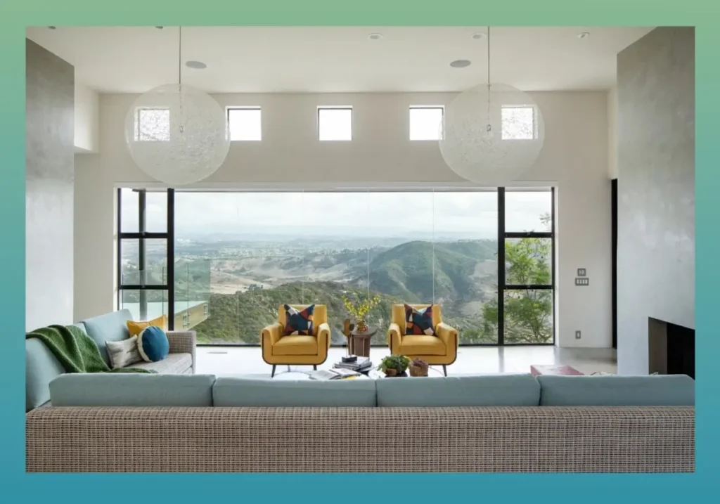 Indoor pool area from Grace Blu’s with window-lined walls, yellow-accented seating, white circular lighting, and glossy floors.