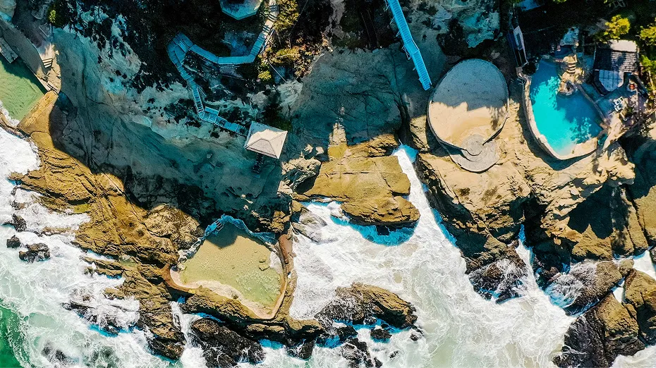 Aerial view of rocky cliffs and tide pools at Laguna Beach with turquoise water, captured for Grace Blu Interior Design