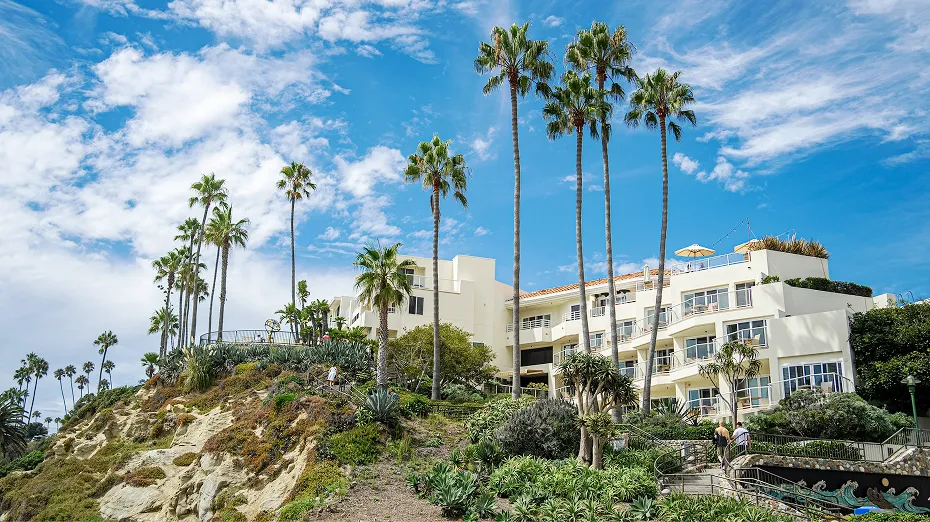 Grace Blu design studio building on a rocky hillside with palm trees in Laguna Beach, California