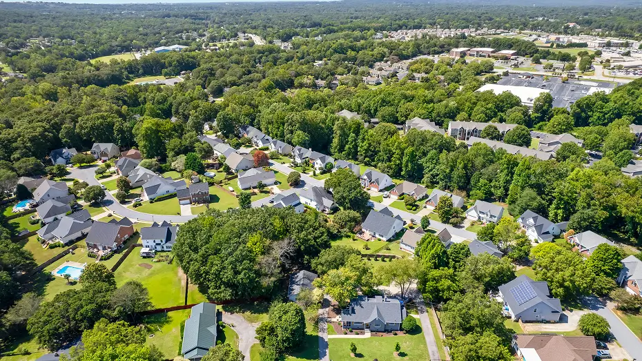 Aerial view of Bluffton, South Carolina neighborhood with tree-lined streets, houses and green spaces captured for Grace Blu Interior Design