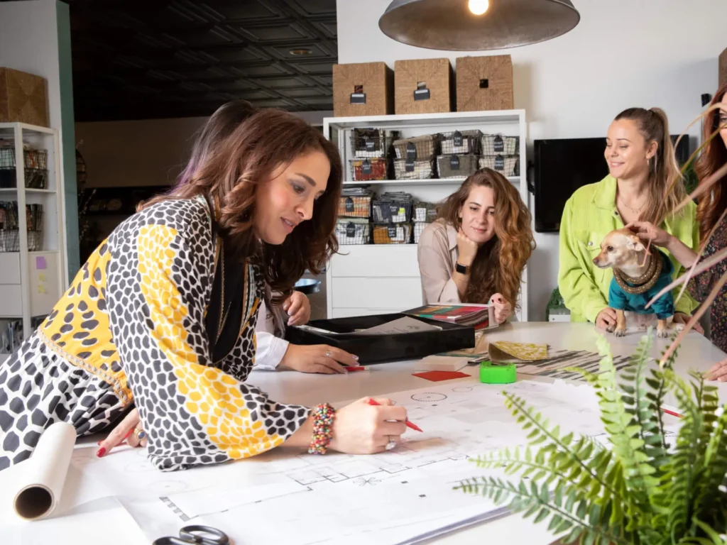 Grace Blu team looking at a blueprint of a house working on interior design