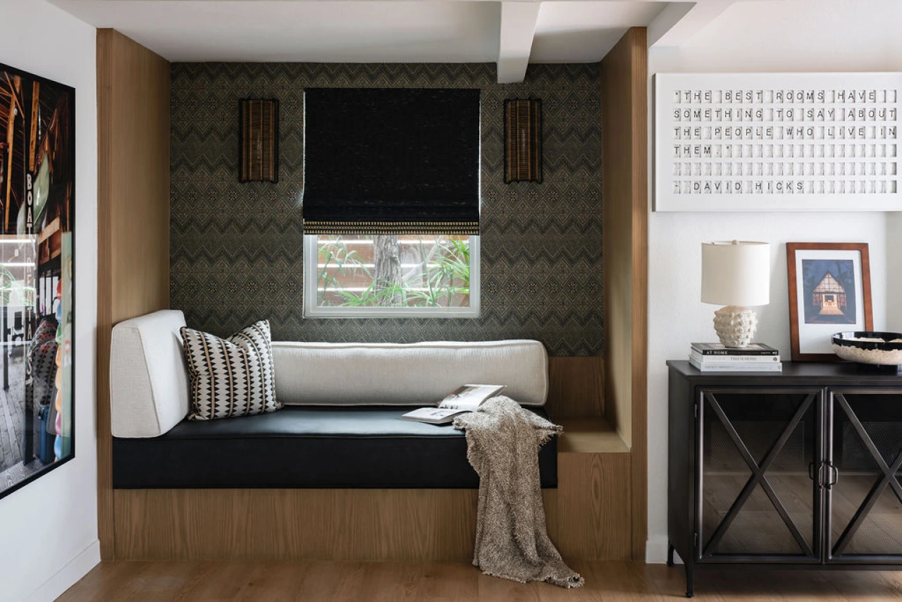 Built-in bench bed from Grace Blu’s Interior Design Project Bungalow Shores with patterned pillows, a cozy throw, and a gray pattern wallpaper.
