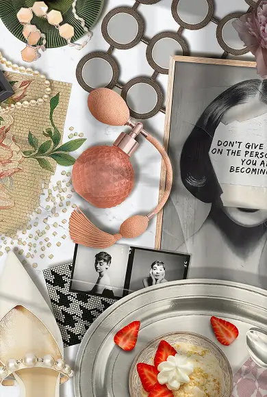 Flat lay with vintage perfume bottle, pearls, black-and-white photos, art print, and strawberries with cream dessert.