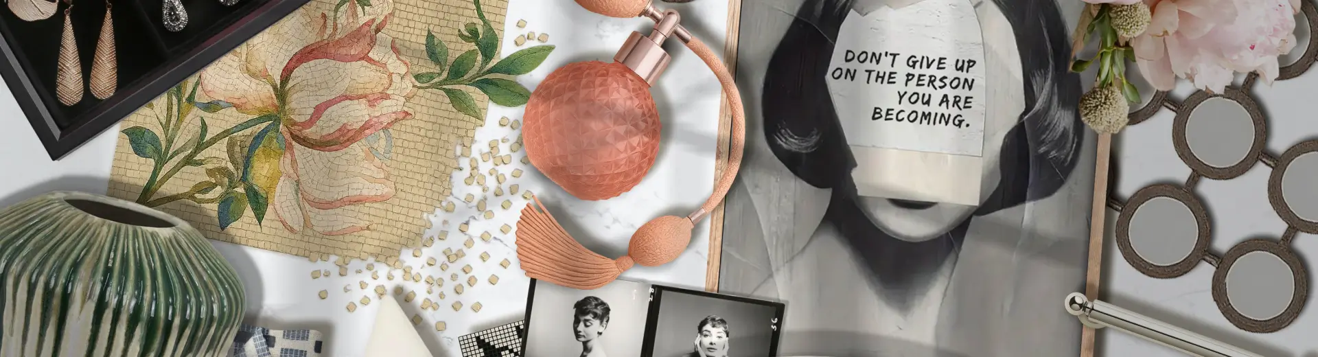 Flat lay with vintage perfume bottle, pearls, black-and-white photos, art print, and strawberries with cream dessert.