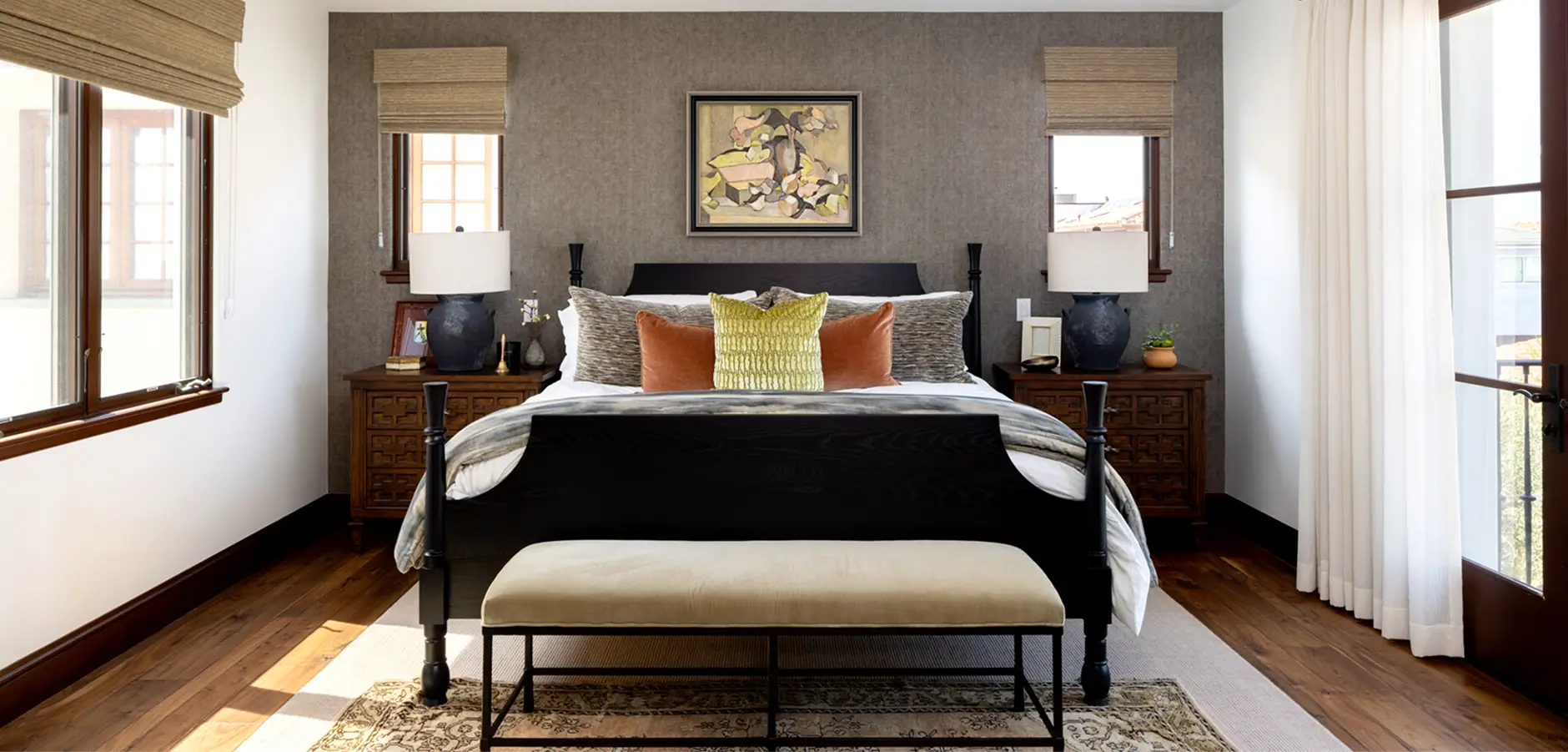 Bedroom with gray wallpaper and yellow bed with dark frame, natural light streaming from balcony door and windows