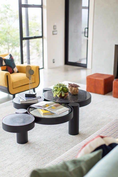 Featured circular, abstract marble coffee table in a living room from Grace Blu's Interior Design Project Sommet Du Monde