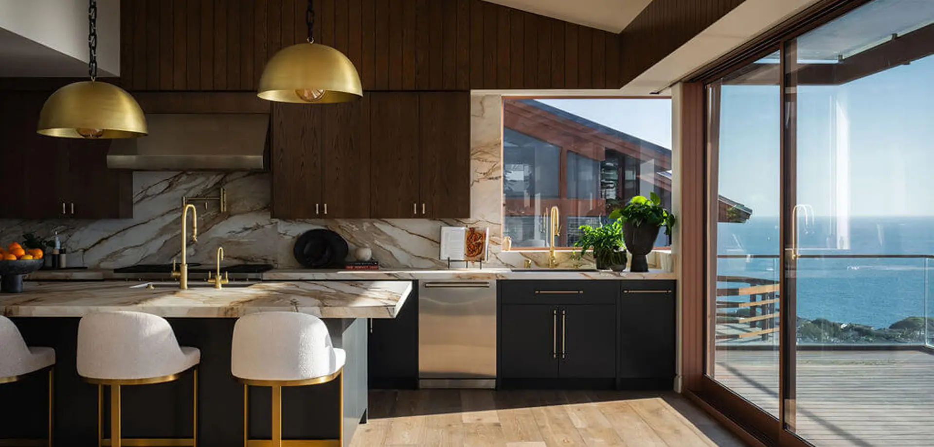 kitchen with dark brown wooden cabinets, light brown floors and marble walls and kitchen island