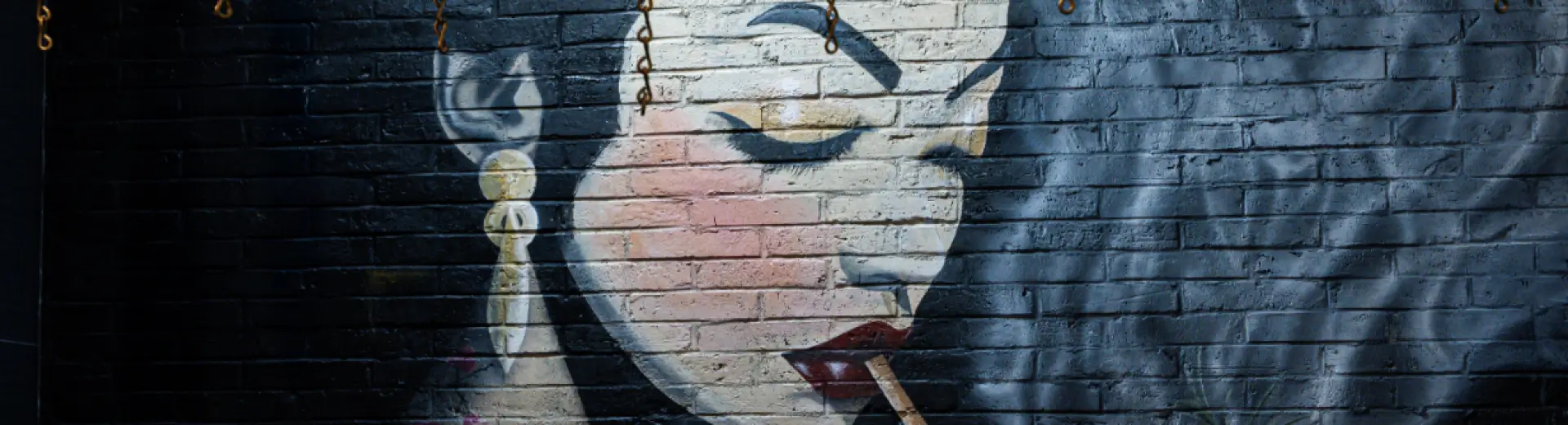 Mural at Yuzu Sushi of an elegant woman with bold makeup smoking beside a drink.