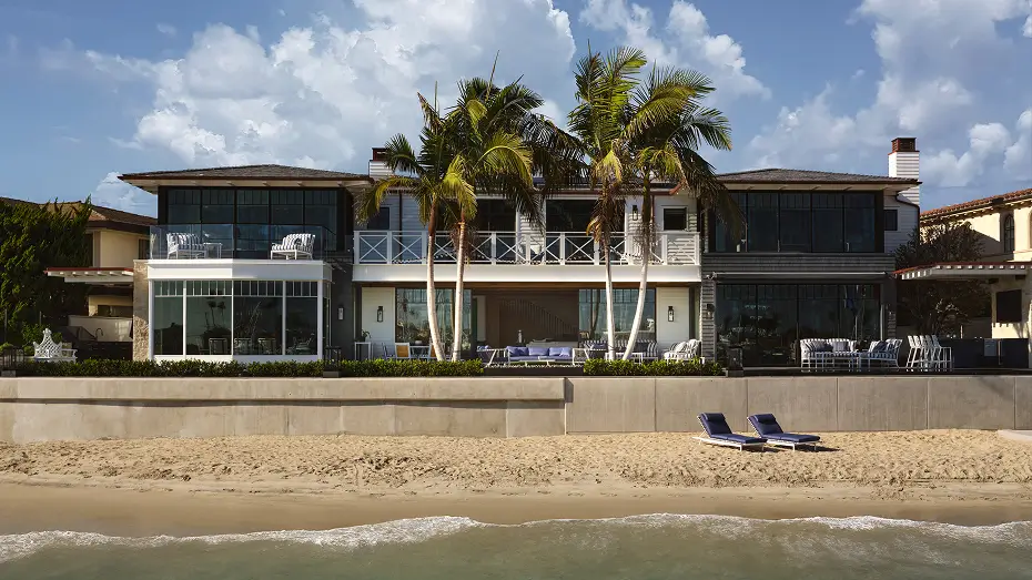 Ocean-front modern, long house with large windows on the top and bottom floors