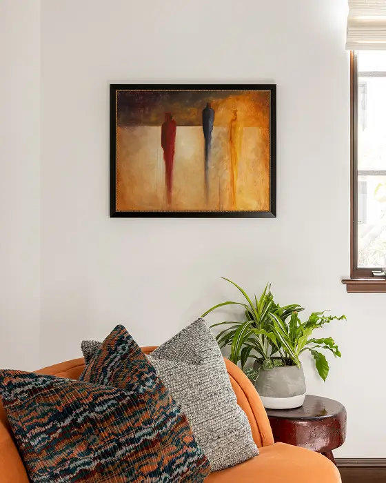 Via Jucar living room with white walls, warm orange accents, and inviting modern artwork.