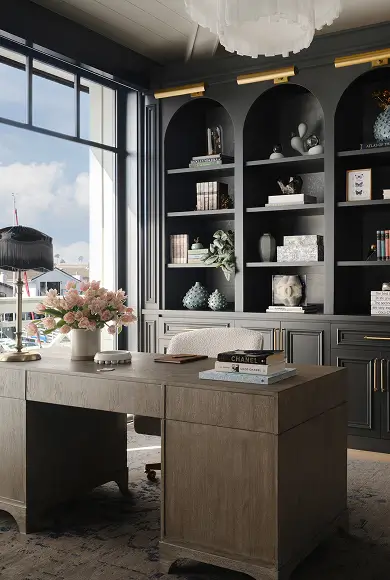 Chic home office with black built-ins, Chanel surfboard, marina view, and curated decor styled by Grace Blu Design.