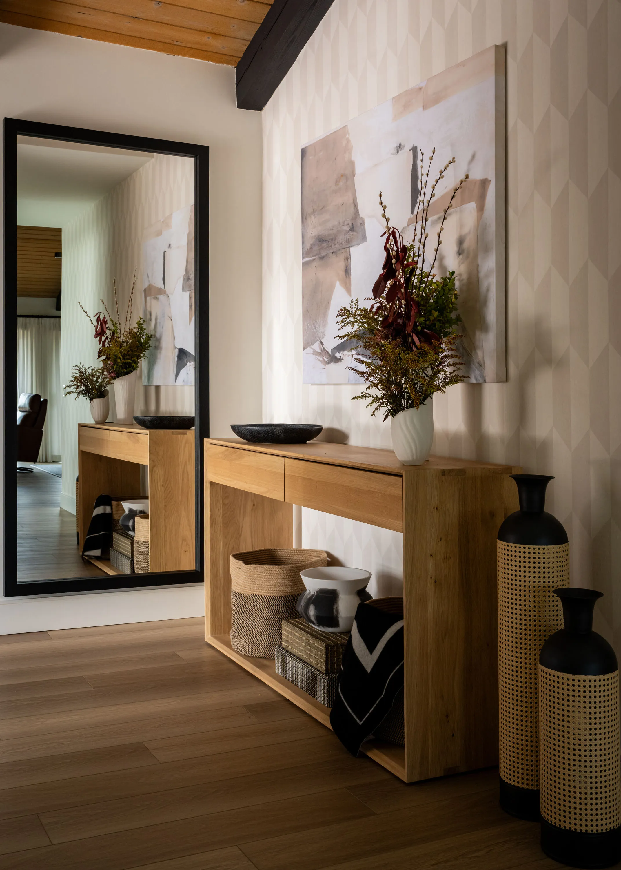 Entry hall with a floor mirror, white oak console and abstract artwork